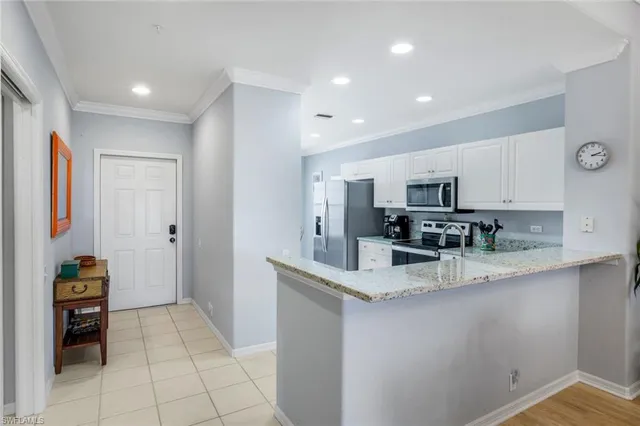 a kitchen with stainless steel appliances granite countertop a sink and cabinets