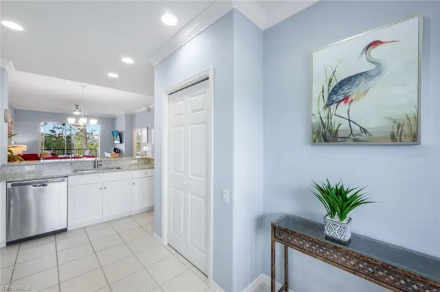 a bathroom with a granite countertop sink a potted plant and a window