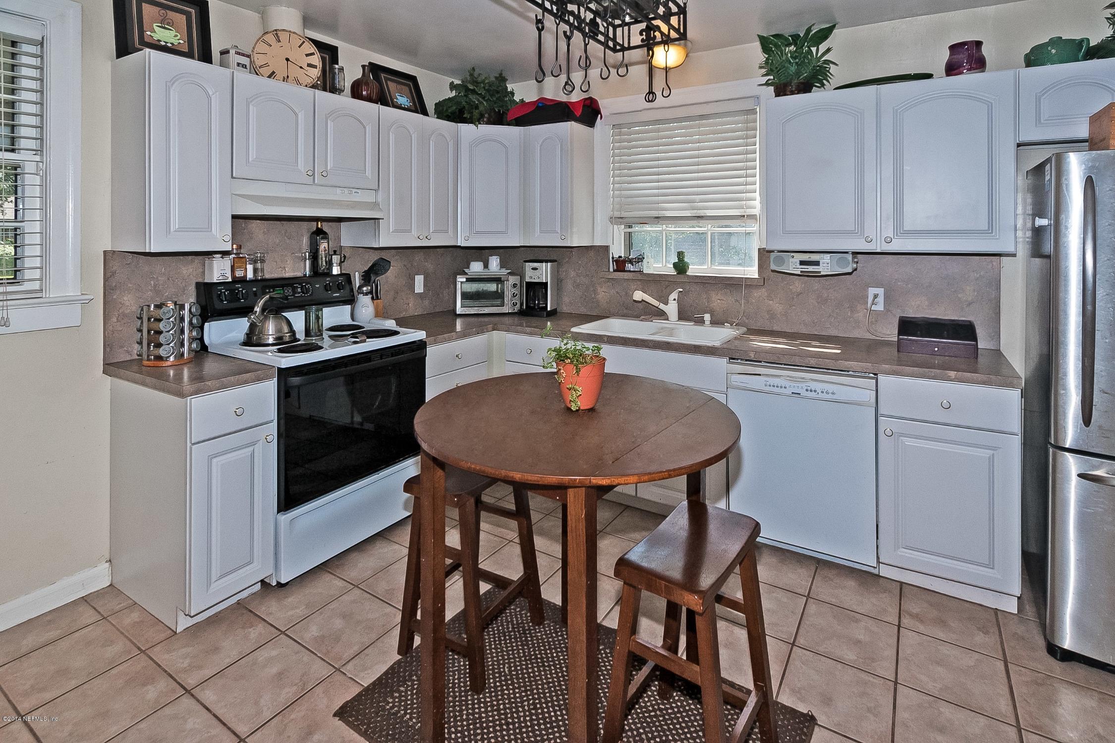 1446 Nicholson Road Jacksonville, FL 32207 - Photo 12 of 27 a kitchen with stainless steel appliances granite countertop a sink a stove a refrigerator and cabinets
