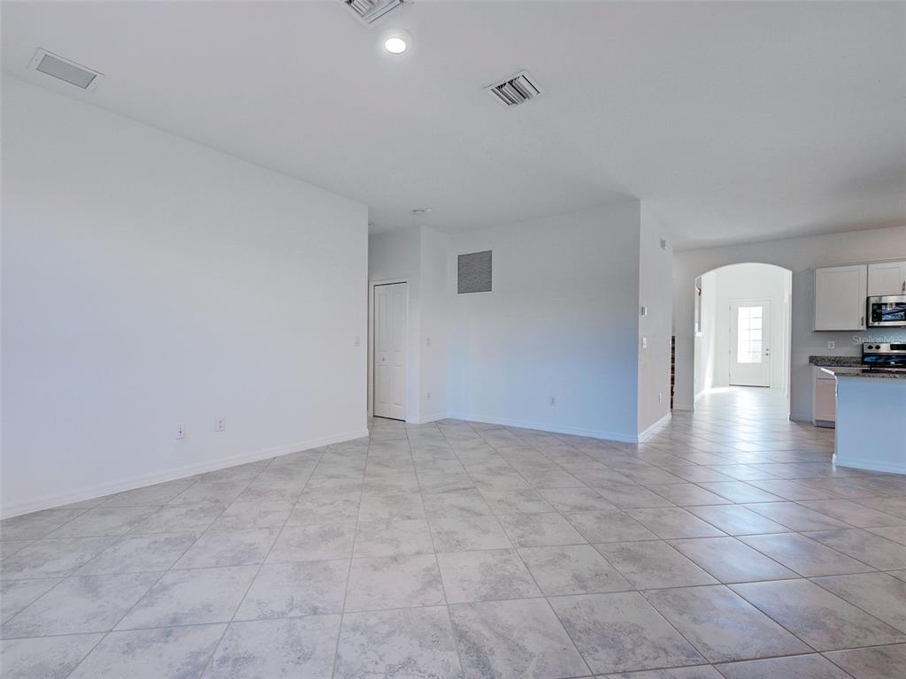 1824 East Isles Rd Port Port Charlotte, FL 33953 - Photo 30 of 80 a view of empty room with kitchen view and a window