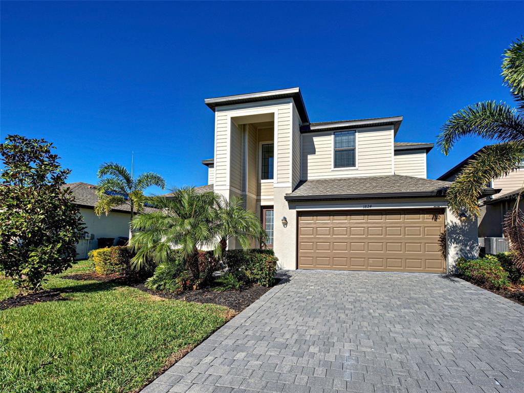 1824 East Isles Rd Port Port Charlotte, FL 33953 - Photo 3 of 80 a front view of a house with a yard