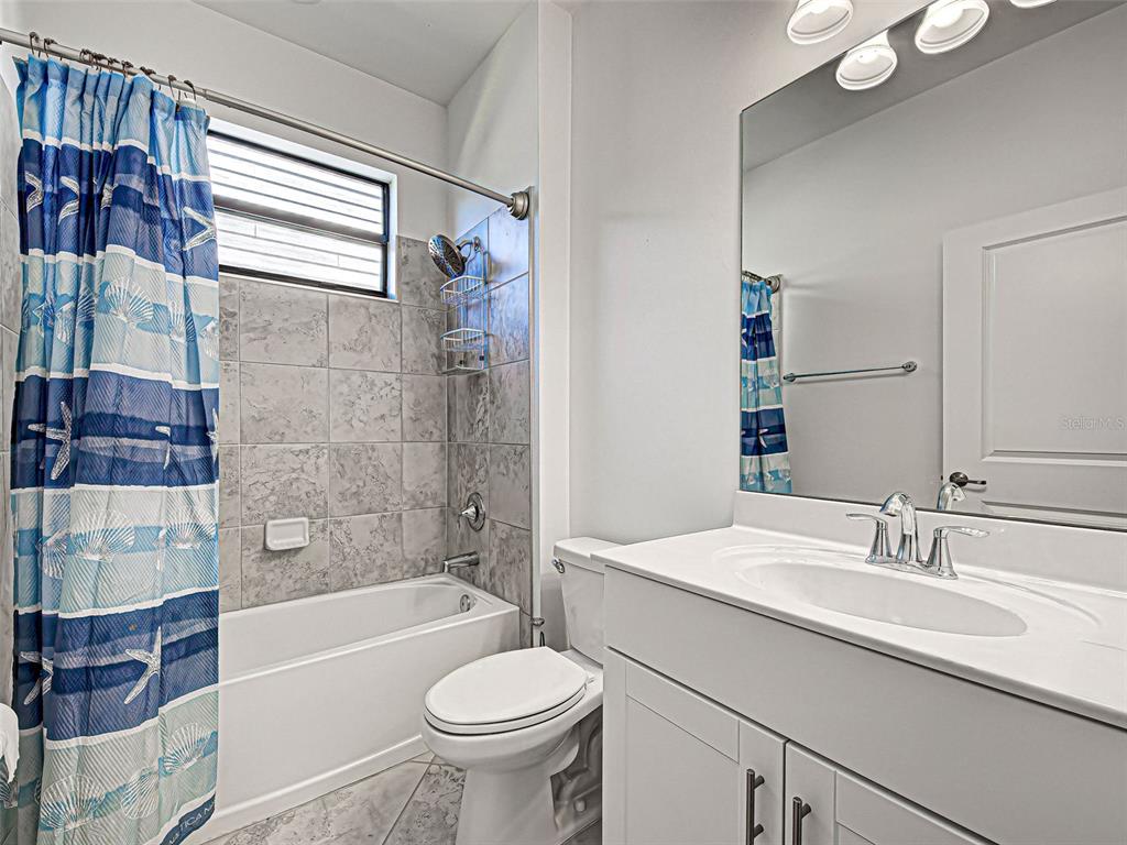 1824 East Isles Rd Port Port Charlotte, FL 33953 - Photo 36 of 80 a bathroom with a sink double vanity mirror bathtub and toilet