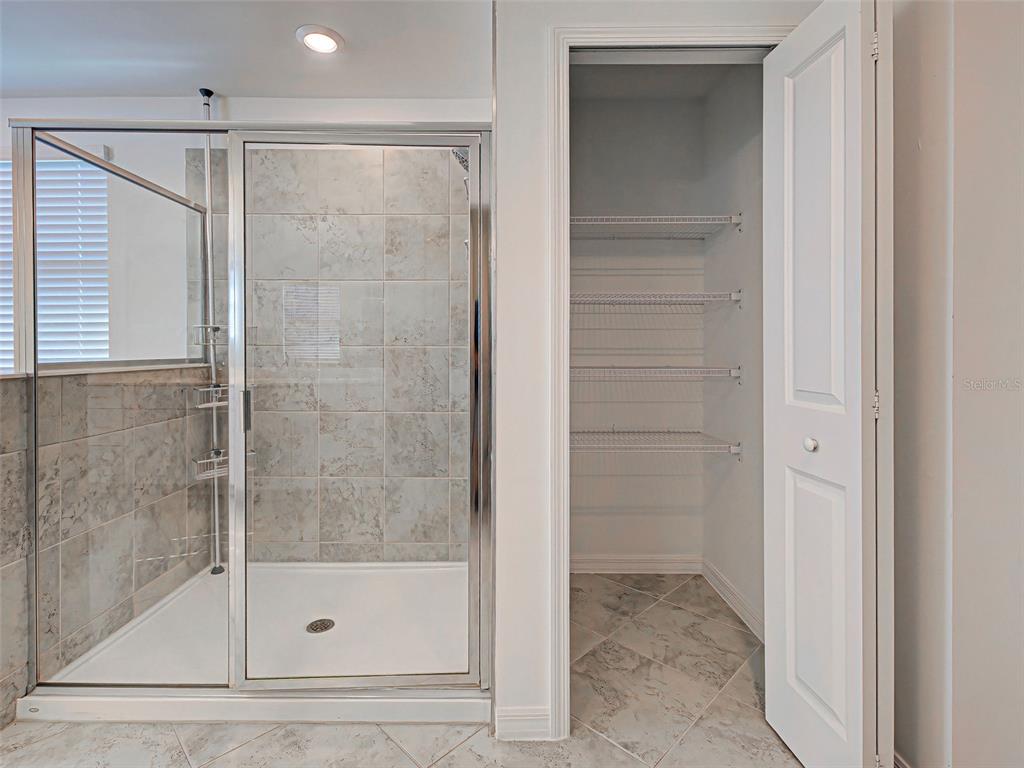 1824 East Isles Rd Port Port Charlotte, FL 33953 - Photo 68 of 80 a bathroom with a glass shower door