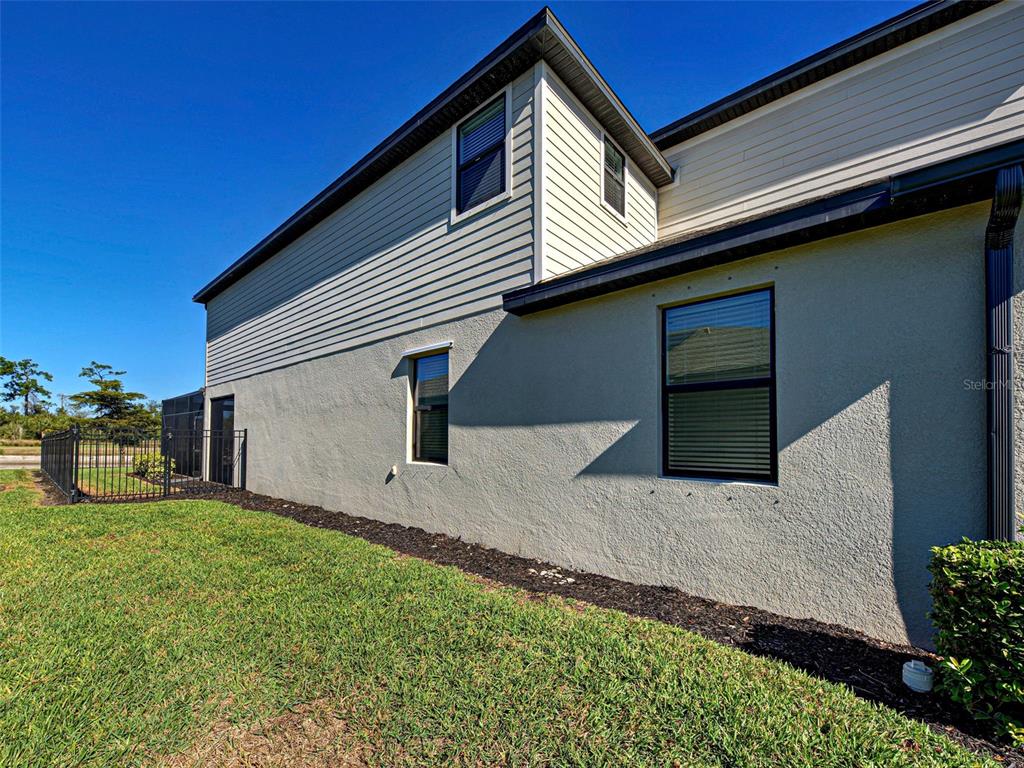 1824 East Isles Rd Port Port Charlotte, FL 33953 - Photo 7 of 80 a backyard of a house with table and chairs with wooden fence