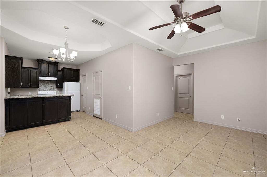 1214 Cornerstone Loop Rio Grande City, TX 78582 - Photo 2 of 15 a view of a kitchen with a sink and a refrigerator