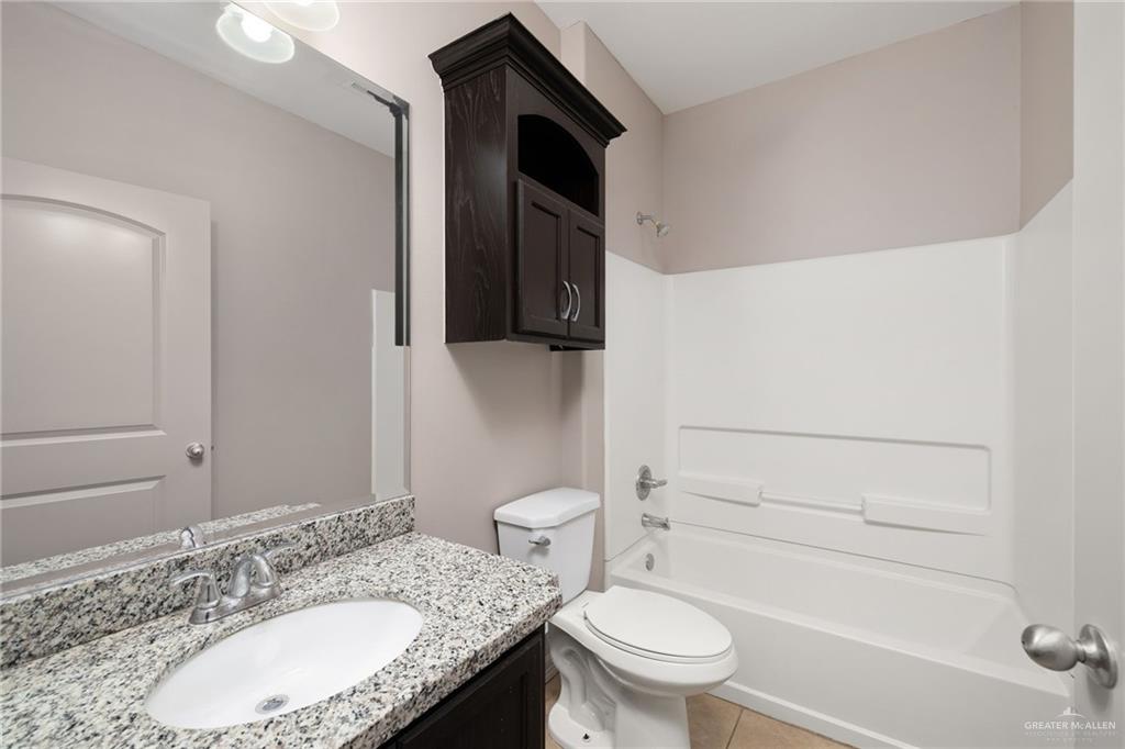1214 Cornerstone Loop Rio Grande City, TX 78582 - Photo 9 of 15 a bathroom with a granite countertop sink toilet and shower