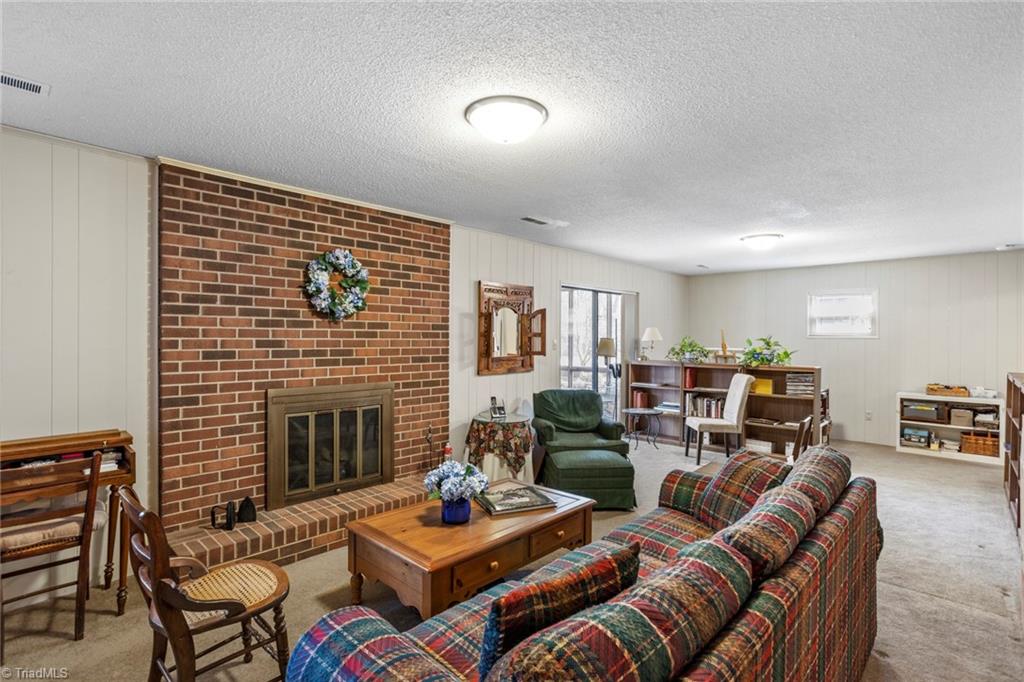 1393 Turkey Hill Road Winston-Salem, NC 27106 - Photo 20 of 36 Playroom in basement has gas log fireplace