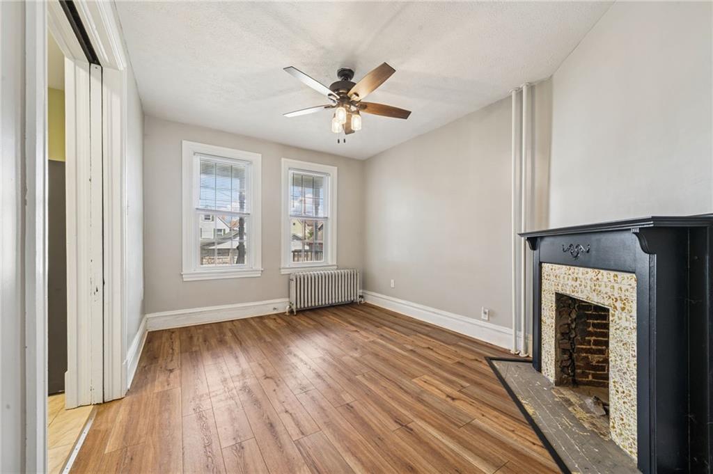 147 Hamilton Avenue Vandergrift, PA 15690 - Photo 11 of 32 a view of an empty room with wooden floor and a window