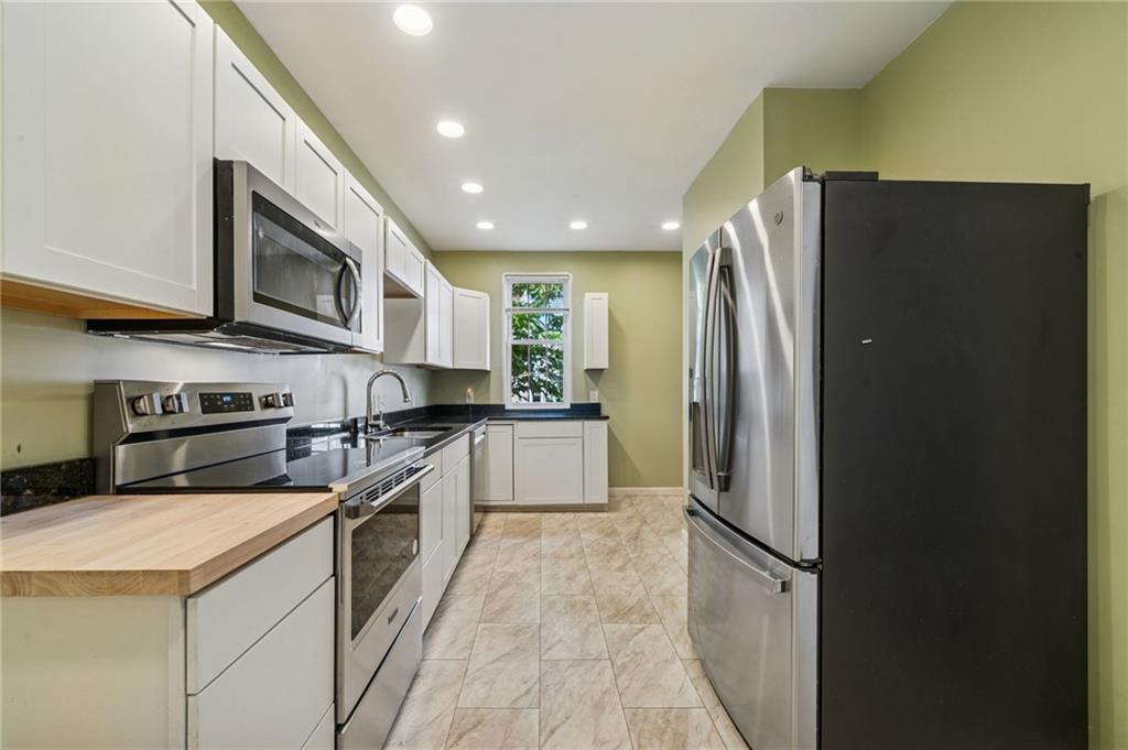 147 Hamilton Avenue Vandergrift, PA 15690 - Photo 14 of 32 a kitchen with stainless steel appliances granite countertop a refrigerator a stove and a sink