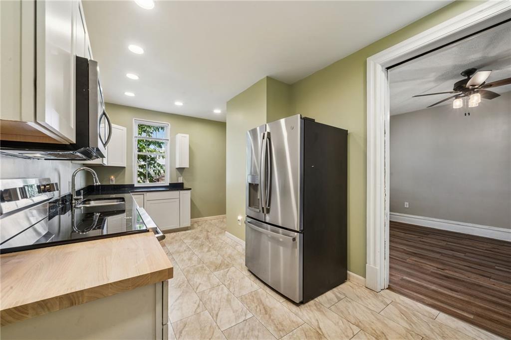 147 Hamilton Avenue Vandergrift, PA 15690 - Photo 15 of 32 a kitchen with granite countertop a refrigerator and a sink