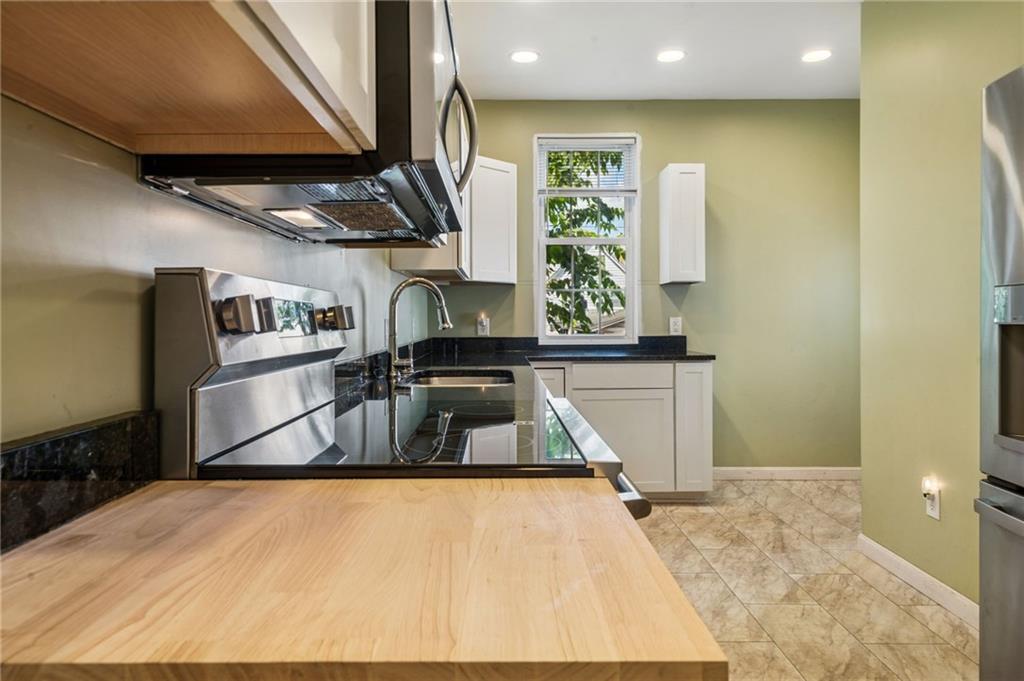 147 Hamilton Avenue Vandergrift, PA 15690 - Photo 18 of 32 a kitchen with stainless steel appliances kitchen island a large counter top and a sink