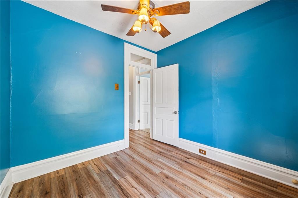 147 Hamilton Avenue Vandergrift, PA 15690 - Photo 21 of 32 a view of a room with wooden floor and fan
