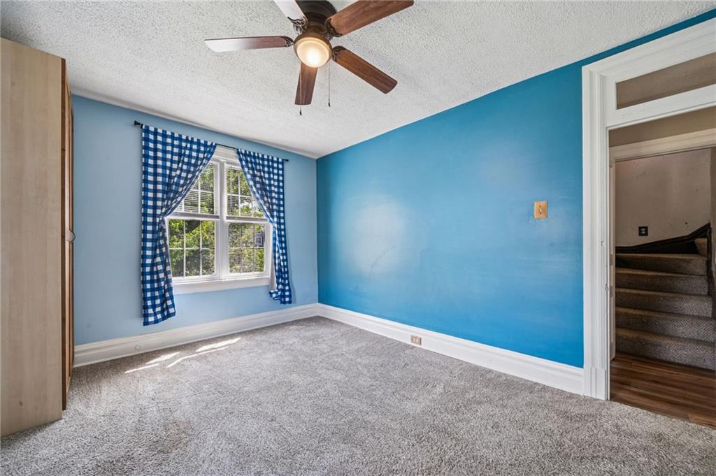 147 Hamilton Avenue Vandergrift, PA 15690 - Photo 24 of 32 an empty room with windows and fan