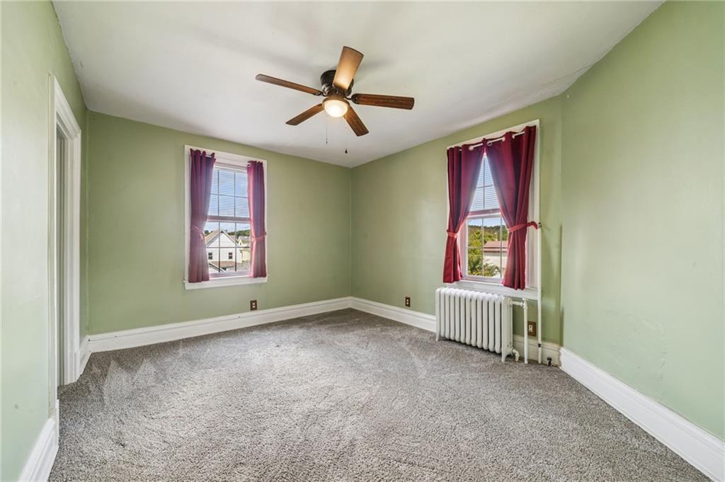 147 Hamilton Avenue Vandergrift, PA 15690 - Photo 26 of 32 an empty room with windows and fan