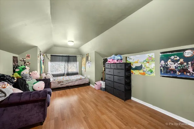 a bedroom with furniture and wooden floor