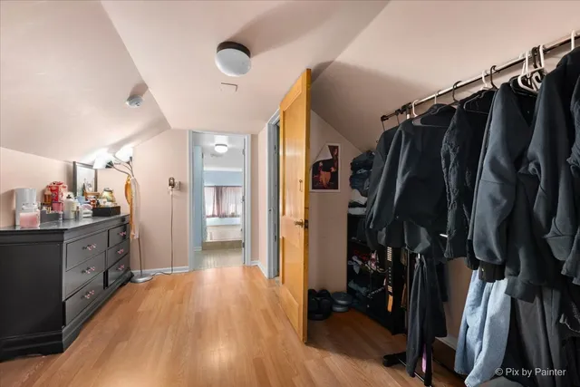 a view of walk in closet with clothes and shoes