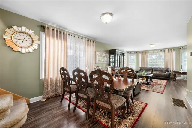a view of a dining room with furniture window and wooden floor