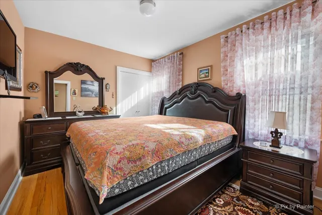 a bed sitting in a bedroom next to a window and dresser