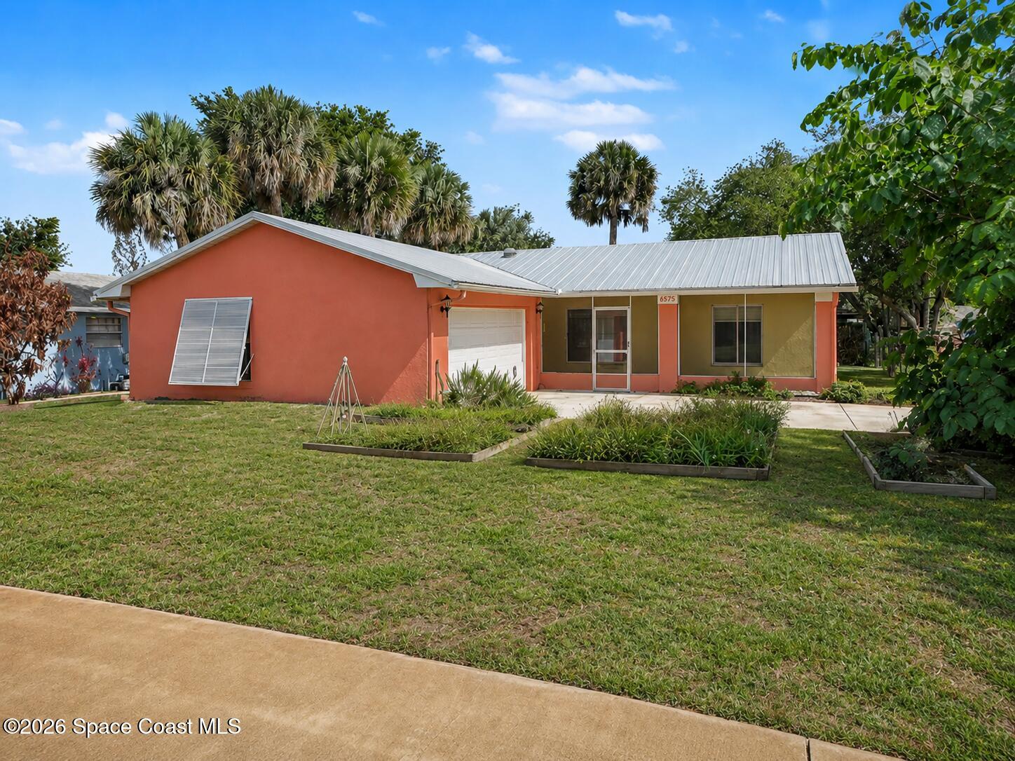 1870 Tallpalm Road Melbourne, FL 32935 - Photo 1 of 30 a backyard of a house with potted plants and large tree