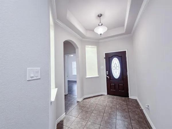 a view of a hallway with entryway wooden floor and front door