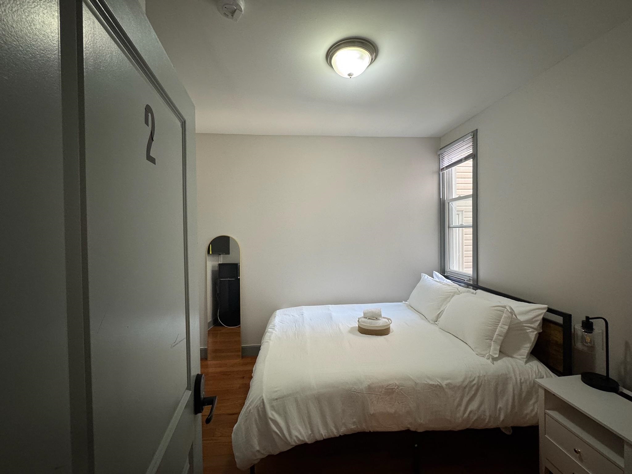 157 Bidwell Avenue, Unit 2 Jersey City, NJ 07305 - Photo 12 of 34 a bedroom with a bed and a window