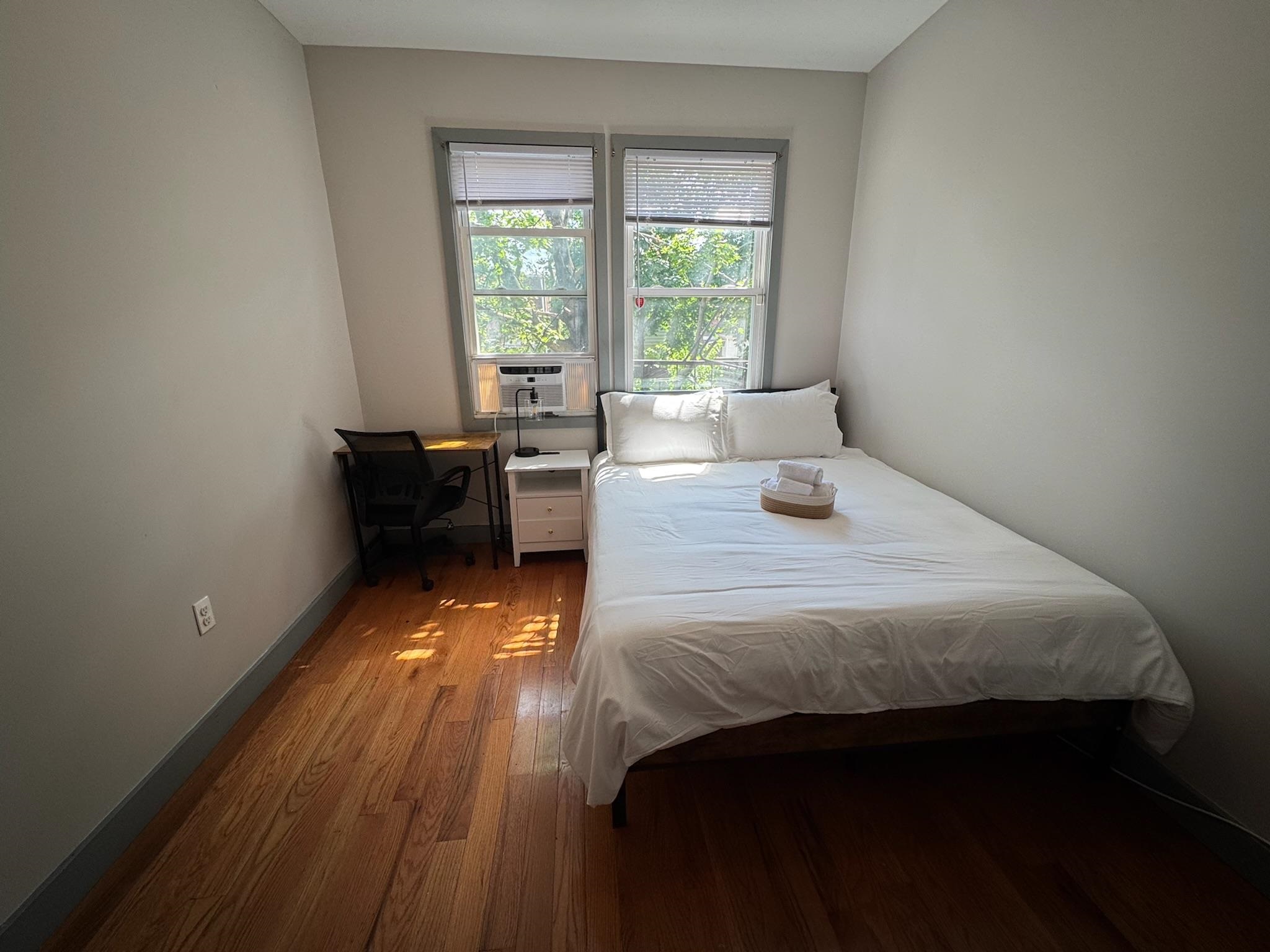 157 Bidwell Avenue, Unit 2 Jersey City, NJ 07305 - Photo 17 of 34 a bedroom with a bed and wooden floor