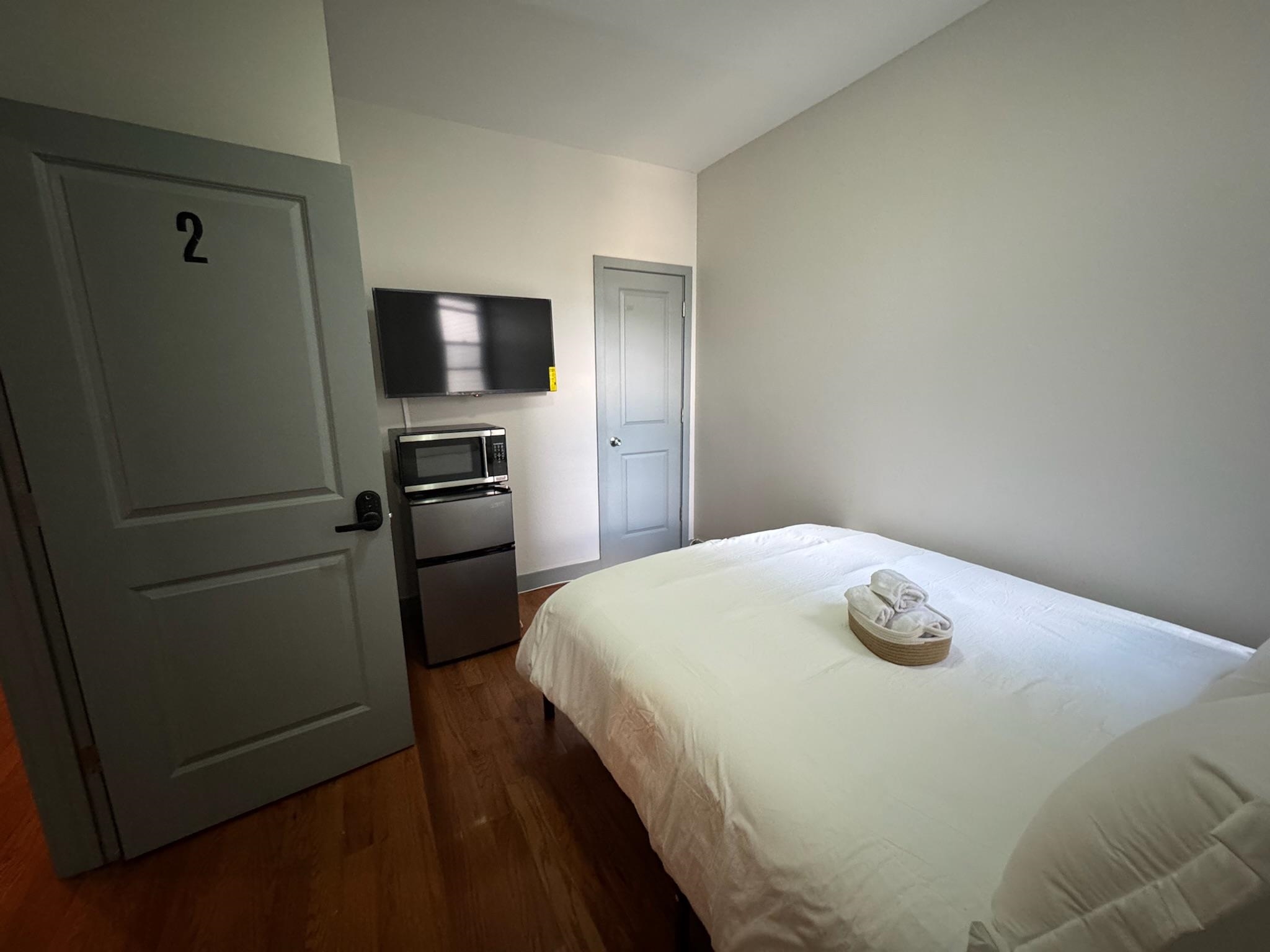 157 Bidwell Avenue, Unit 2 Jersey City, NJ 07305 - Photo 23 of 34 a bedroom with a bed and a tv