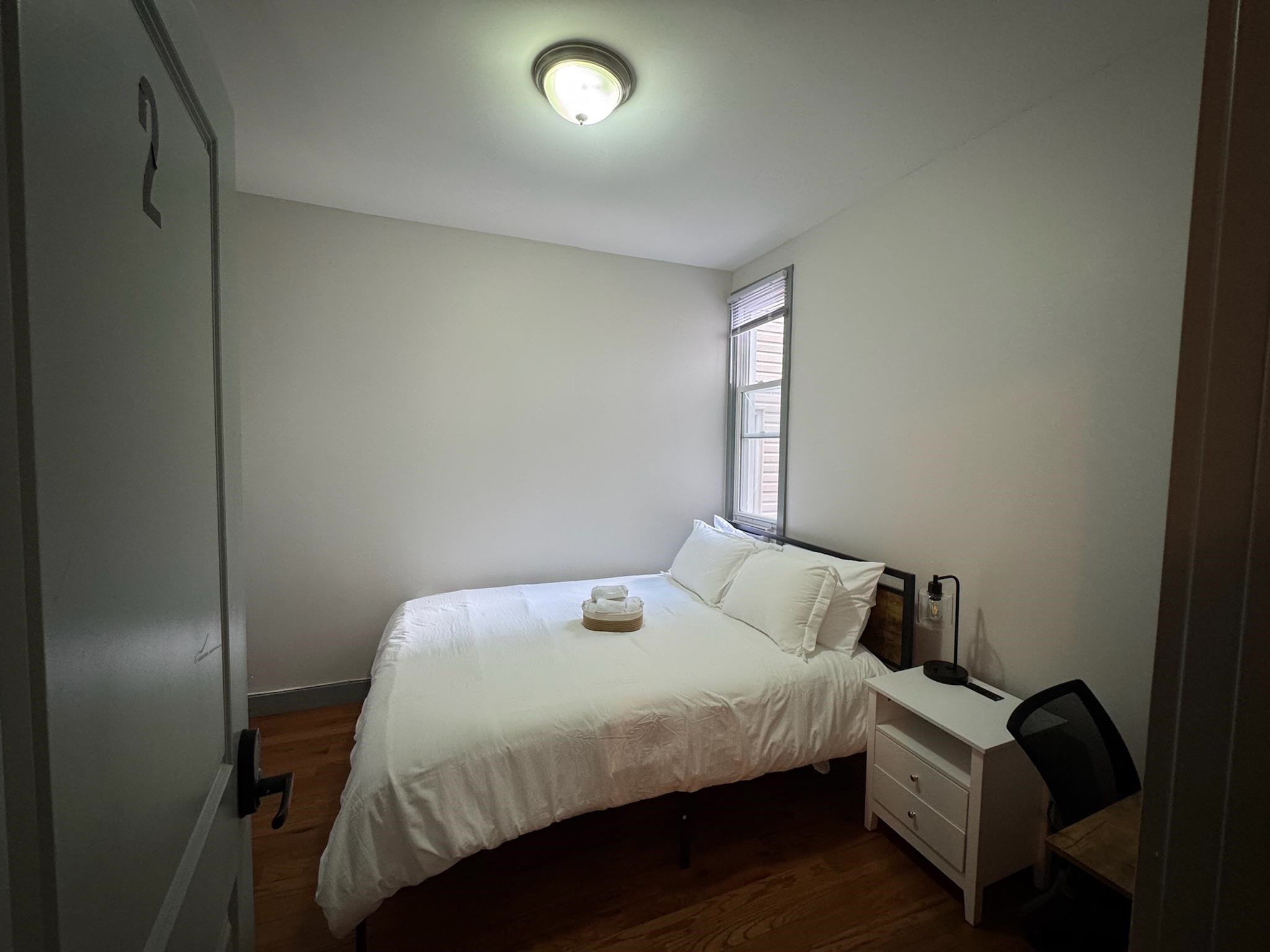 157 Bidwell Avenue, Unit 2 Jersey City, NJ 07305 - Photo 24 of 34 a bedroom with a bed and a window