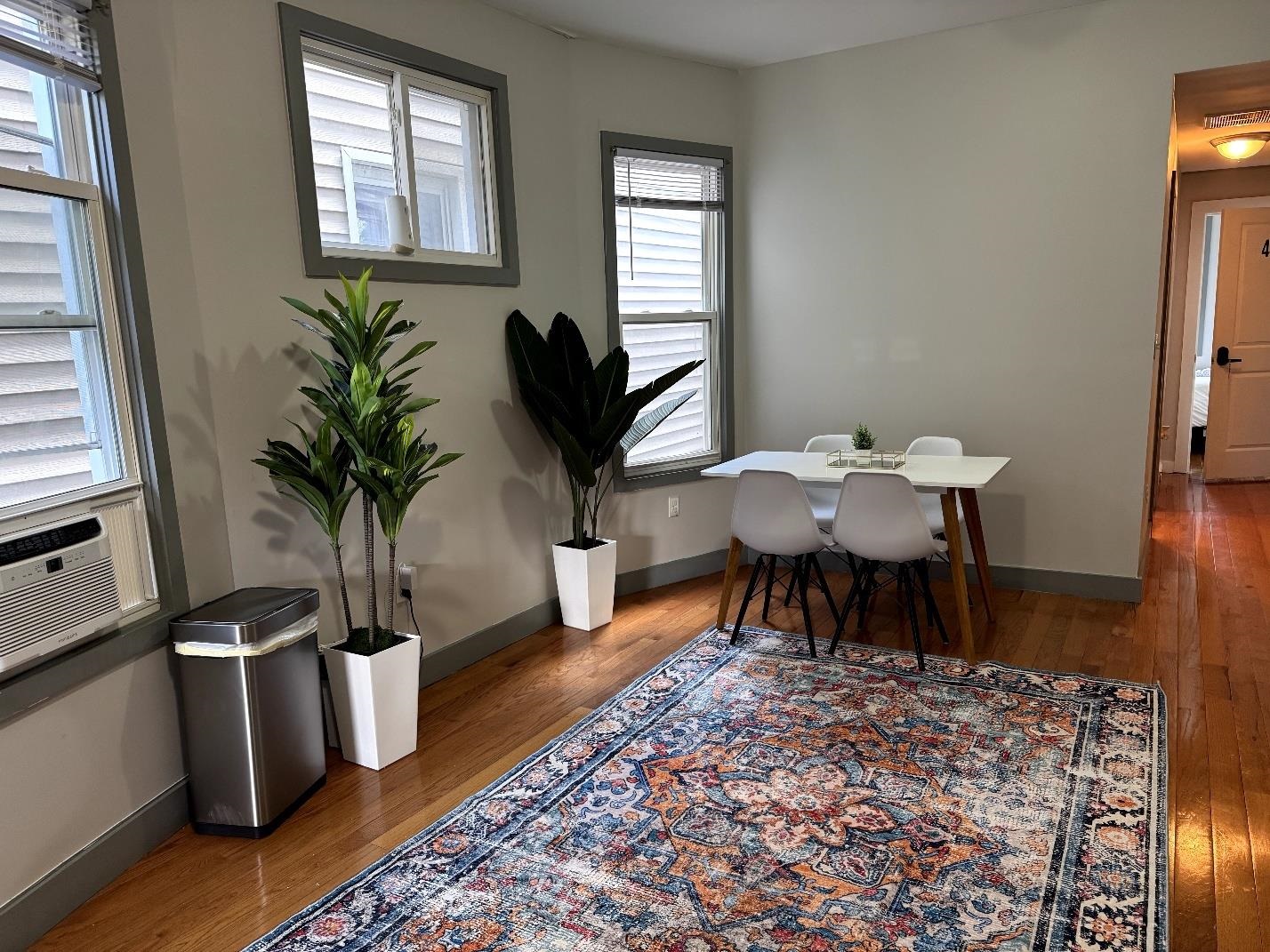 157 Bidwell Avenue, Unit 2 Jersey City, NJ 07305 - Photo 7 of 34 a dining room with furniture a rug and wooden floor