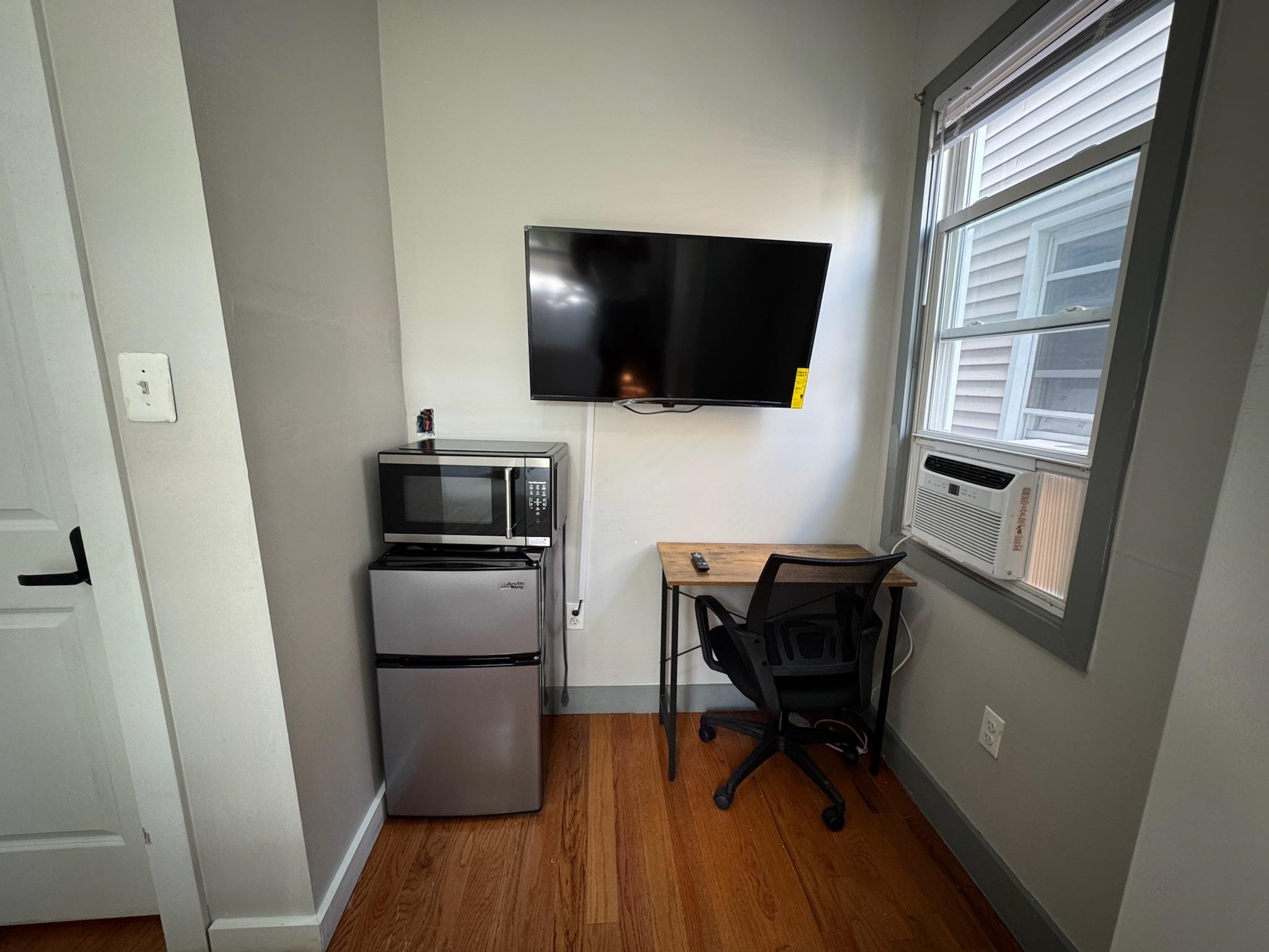 157 Bidwell Avenue, Unit 2 Jersey City, NJ 07305 - Photo 8 of 34 a living room with furniture and a flat screen tv