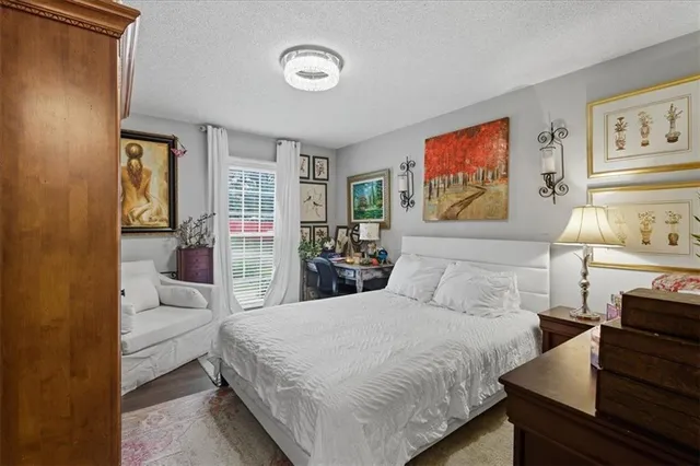 a bedroom with a large bed and a couch