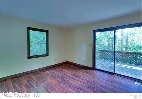 105 Lantern Way Carrboro, NC 27510 - Photo 5 of 9 an empty room with wooden floor and windows