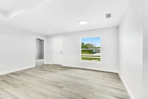 a view of an empty room with a window