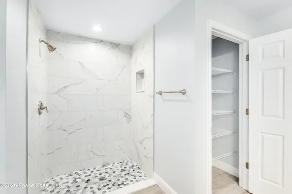 a bathroom with a shower and a sink
