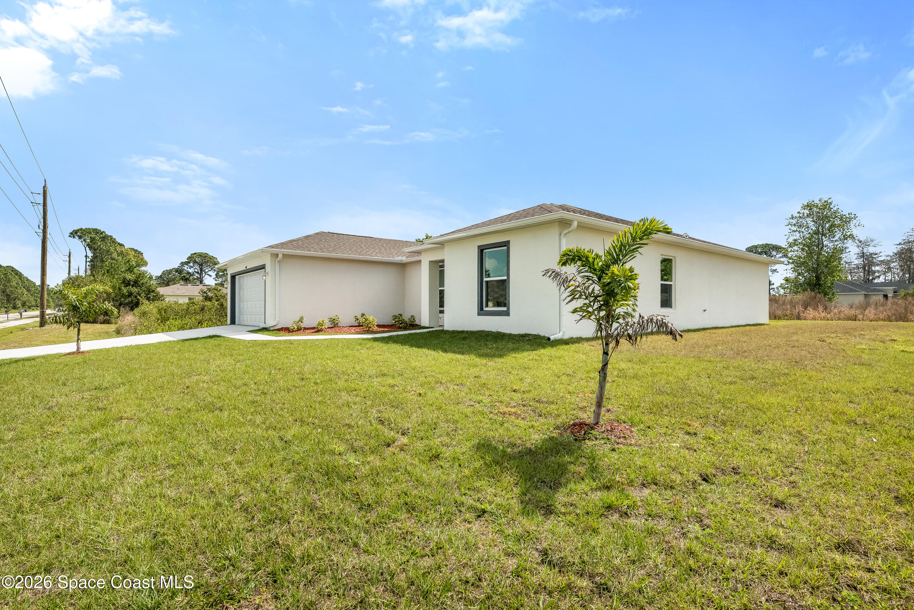 2977 Fig Road Southeast Palm Bay, FL 32909 - Photo 3 of 38 a front view of house with yard and green space