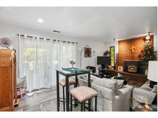 a living room with furniture a flat screen tv and a large window