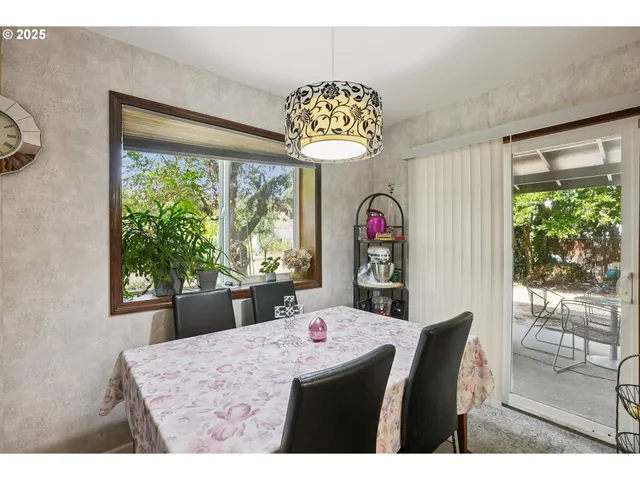 a view of a dining room with furniture a chandelier and wooden floor