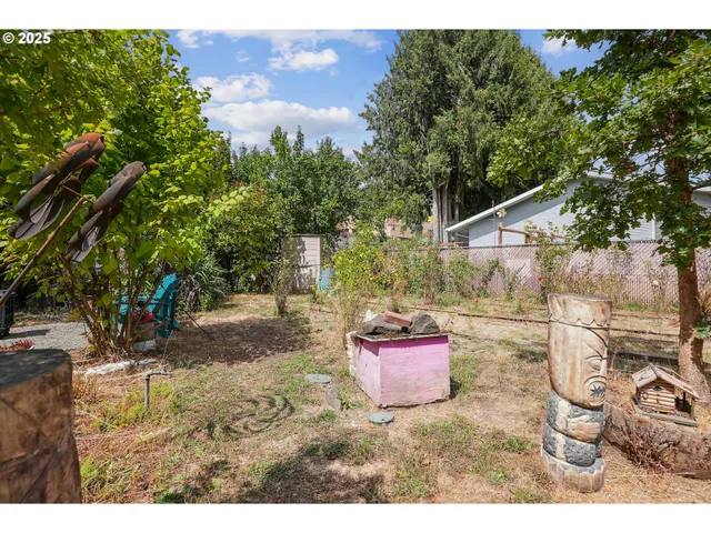 a backyard of a house with table and chairs