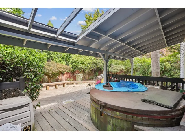 a view of a patio with table and chairs potted plants with wooden floor and fence