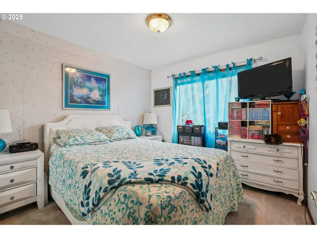 a bedroom with a bed and a flat screen tv