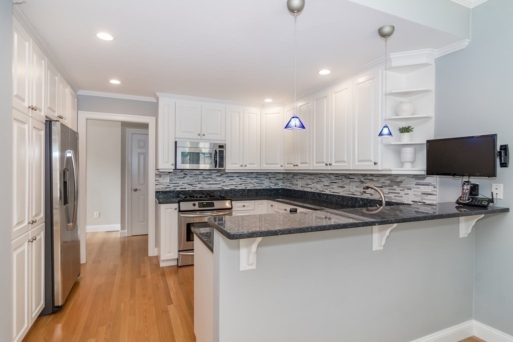 63 Crescent Road, Unit 63 Needham, MA 02494 - Photo 8 of 21 a kitchen with a sink stove and refrigerator