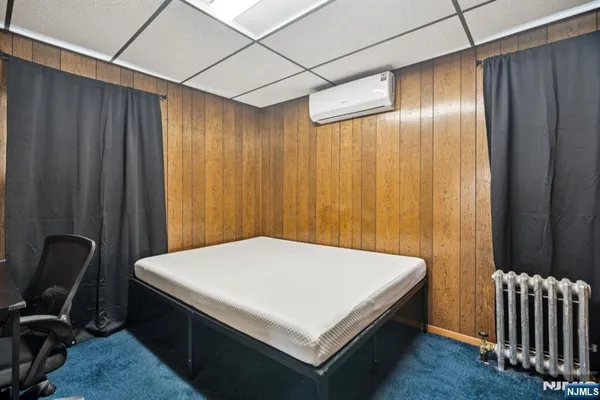 a bed sitting in a room next to a chair