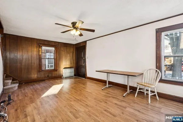 a view of workspace with furniture window and wooden floor