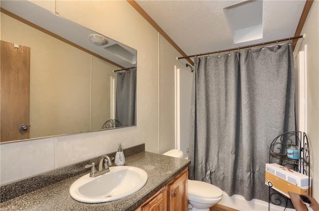 4425 State Rte 18 New Castle, PA 16102 - Photo 12 of 22 a bathroom with a granite countertop sink toilet and a mirror