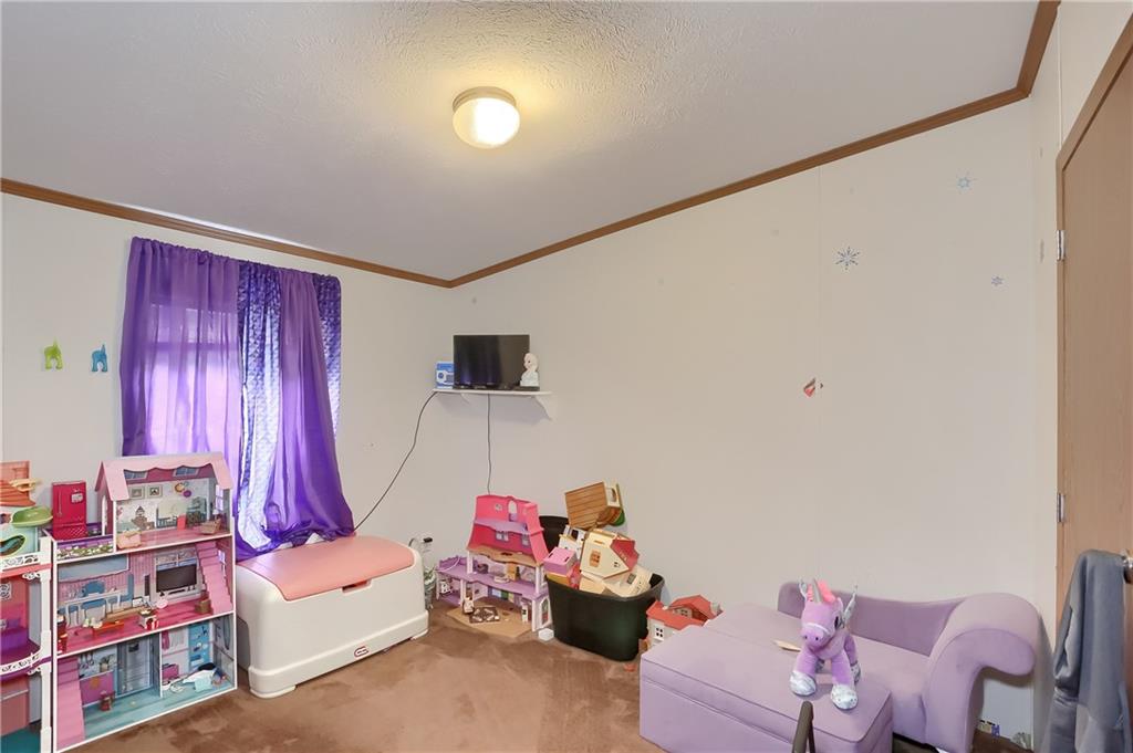 4425 State Rte 18 New Castle, PA 16102 - Photo 13 of 22 a bedroom with furniture and a chandelier
