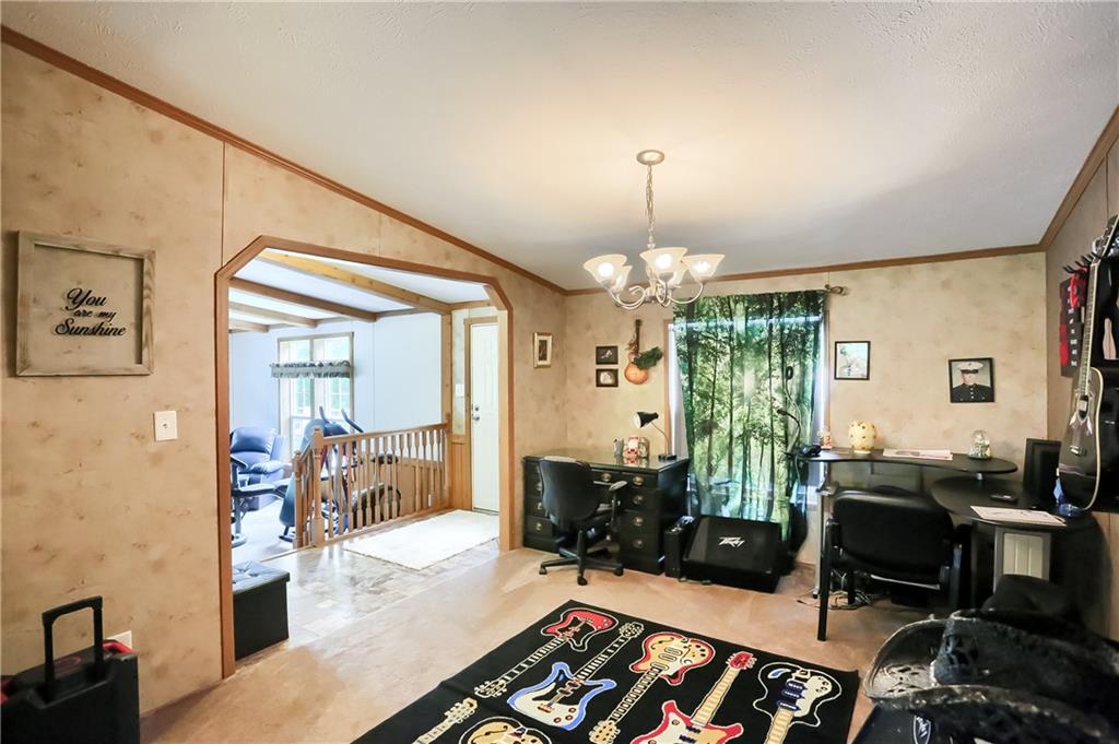 4425 State Rte 18 New Castle, PA 16102 - Photo 8 of 22 a living room with furniture and a chandelier