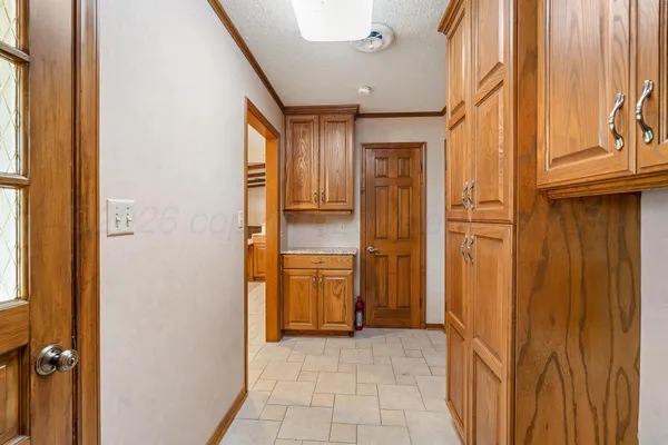 a view of a hallway with a cabinet and door
