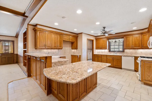 a kitchen with stainless steel appliances granite countertop a sink counter space cabinets and a large window