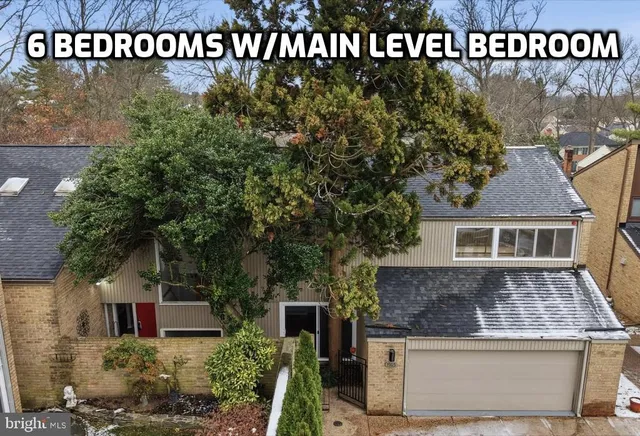 a kitchen with stainless steel appliances granite countertop a refrigerator a sink dishwasher a stove white countertops and wooden floor