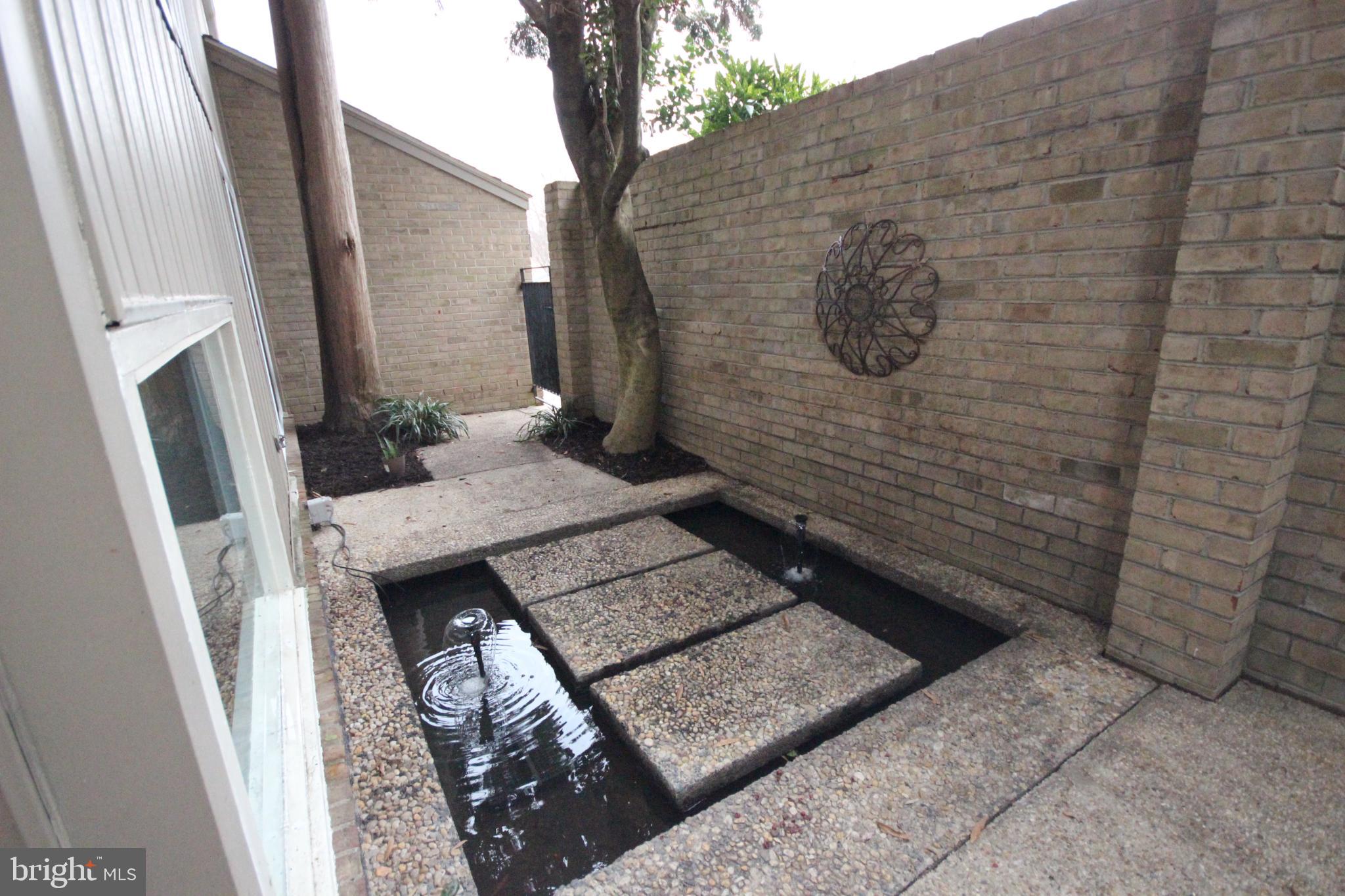 19115 Roman Way Montgomery Village, MD 20886 - Photo 1 of 67 Tranquil courtyard entrance w/serene water feature